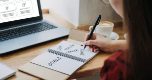 A woman writing down goals